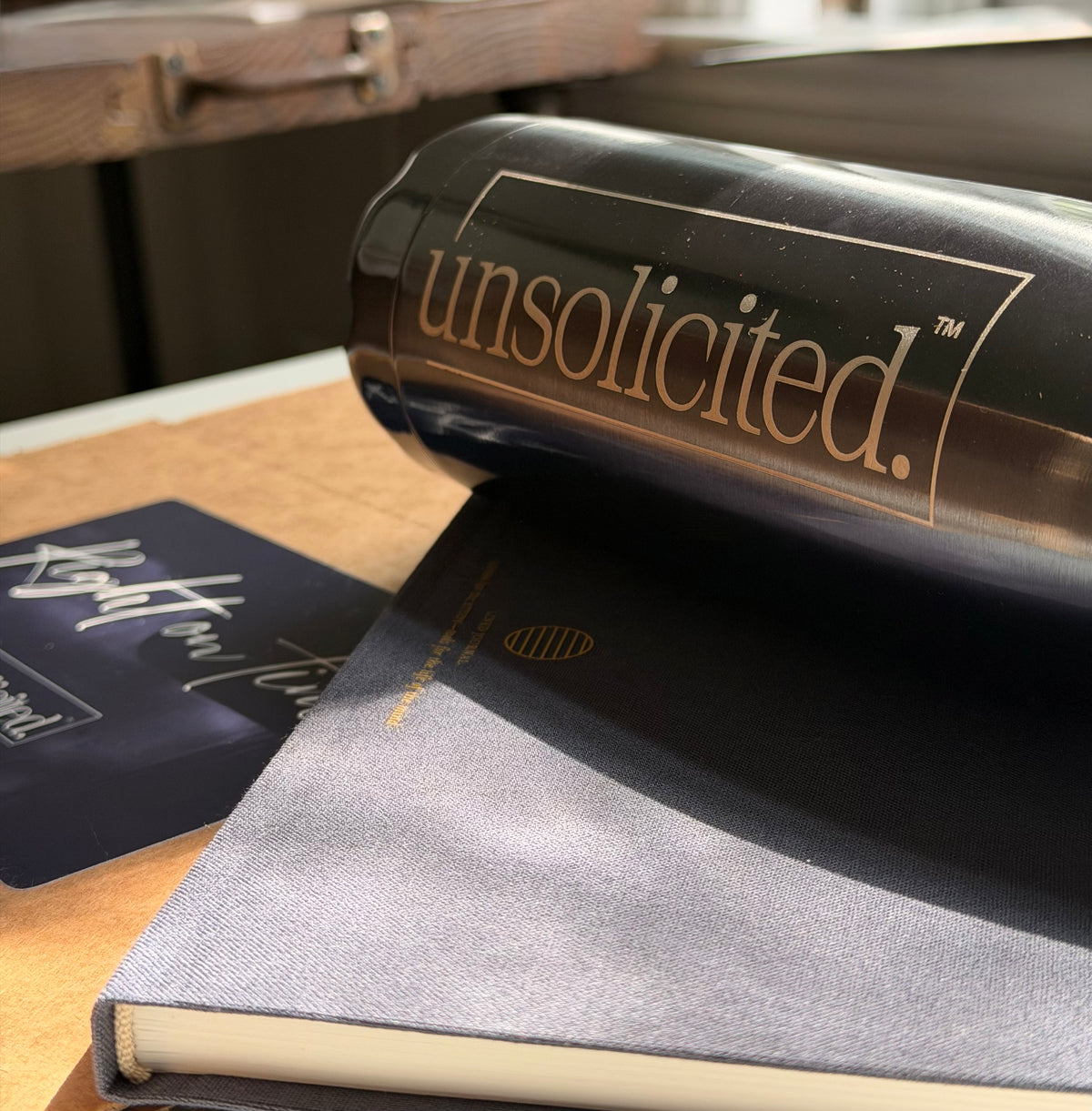 Navy unsolicited. tumbler resting on a navy journal beside a Right on Time card.
